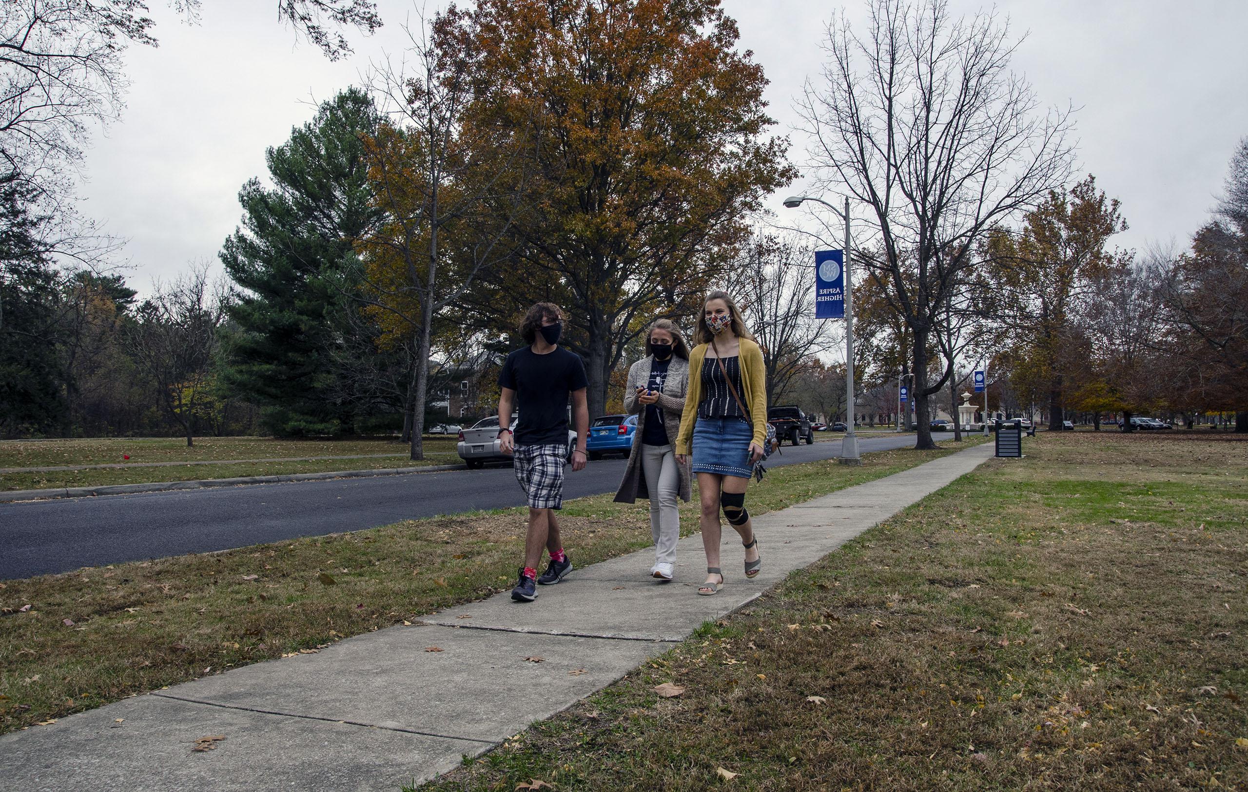 Three students walking down the Avenue